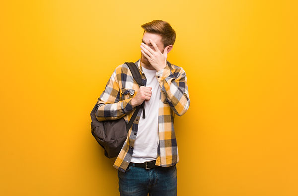 young-redhead-student-man-embarrassed-an
