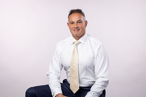 Lawrence Peeter, Dunedin Real Estate Expert sitting in a chair