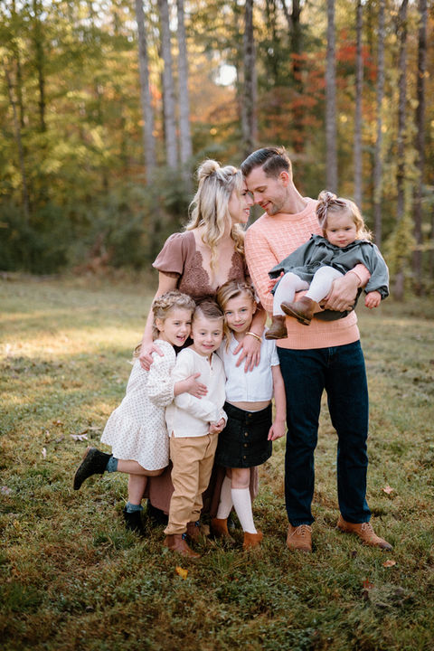 Family portrait surrounded by fall colors during outdoor photo session