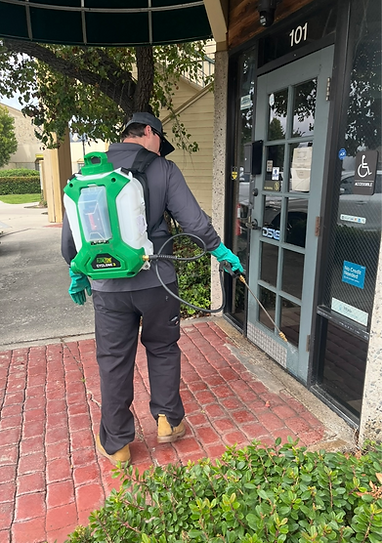 Pest control technician in Temecula, Murrieta, and Menifee spray a commercial building for pest control services