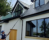 SSR cleaner checking a home from the ground with a water-fed pole