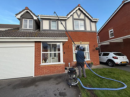 SSR window cleaner using a water-fed pole on a detached house