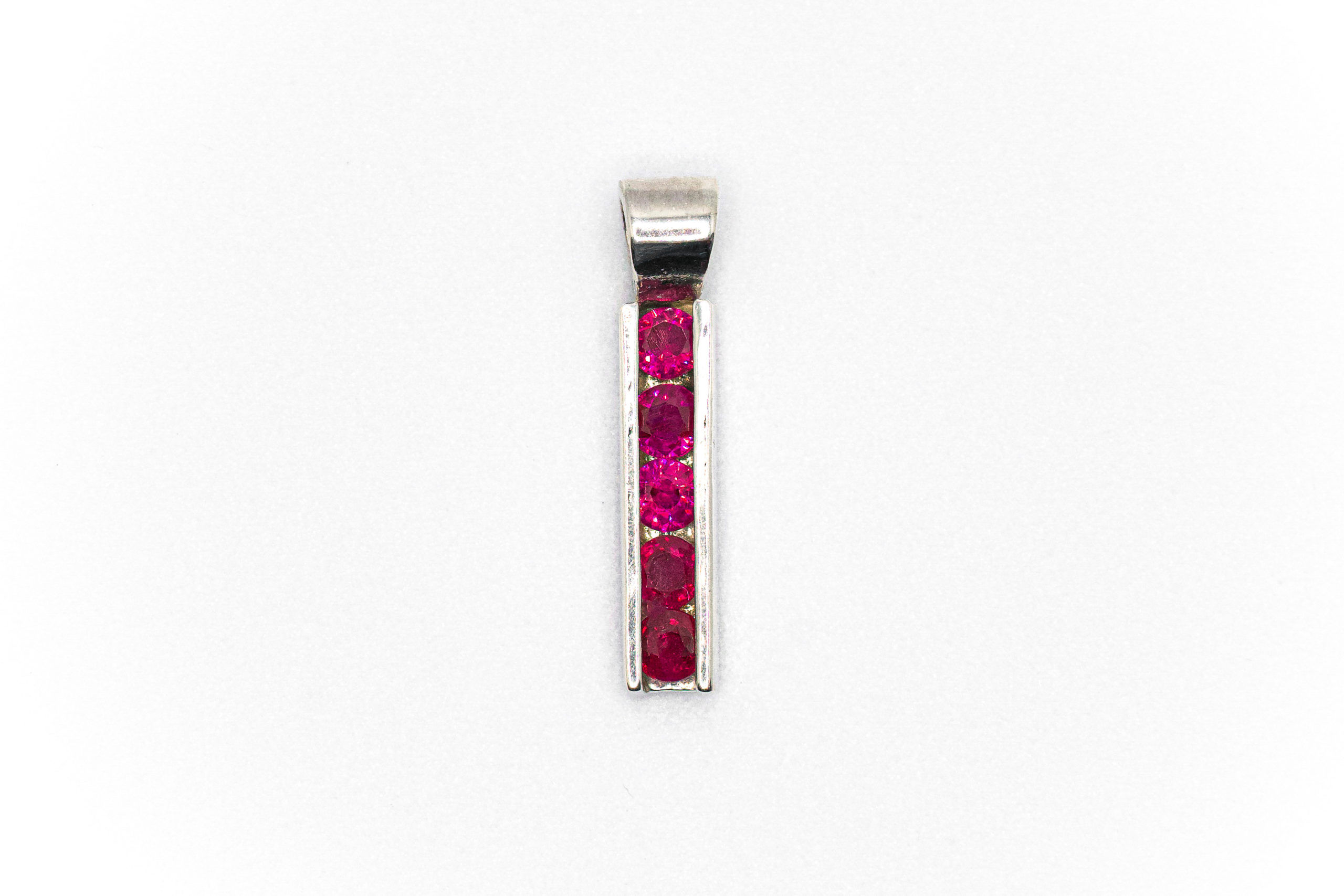 Ruby red round sterling silver channel pendant