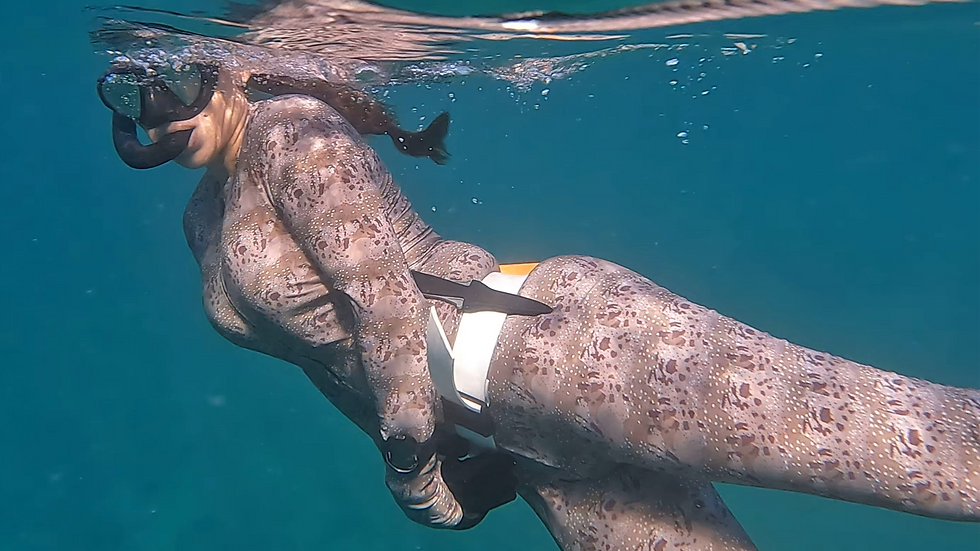 Lone swimmer fully exposed on open ocean surface – Plunge Waterwear UPF 50 dive suits and dive skins essential at the best freediving destinations