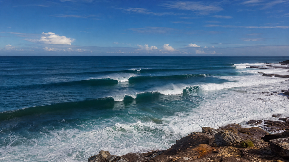 Powerful ocean swell lines rolling toward a rocky coastline — reading swell height, period and direction before diving, Plunge Waterwear dive skins dive suit UPF 50+