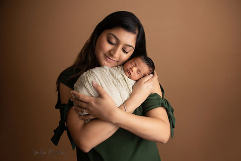 Newborn baby boy posing with mom 