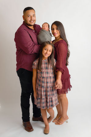 Newborn baby boy posing with family 