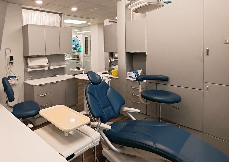 Dental examination room with blue chair and equipment
