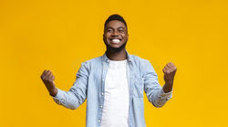 joyful-black-guy-rejoicing-success-clenc