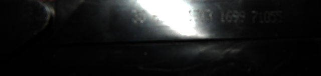 A dark image of a VHS tape, trying to make out the numbers and markings on it.