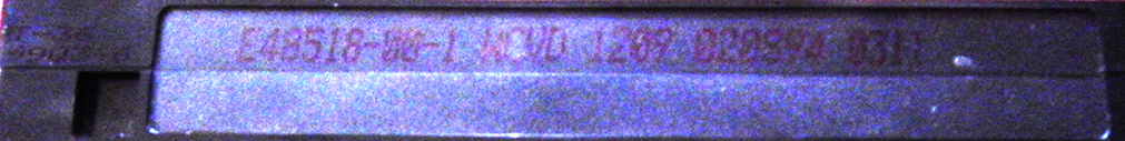 The image of black ink VHS tape info enhanced to be more legible. It appears to say, "E48518-00-1 WCVD 1209 020894 0311."