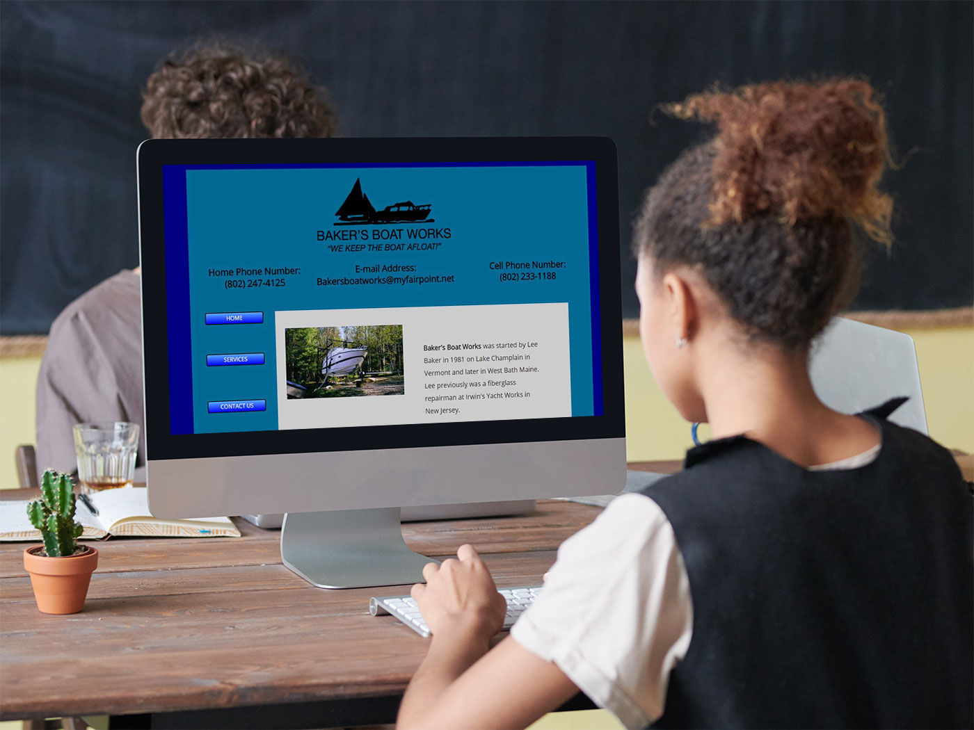 A young girl looking at the Baker's Boat Works website, presumably for looking for service for her parents' boat or something.