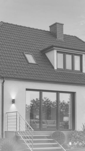Dusk exterior visualization of a private house with warm interior lights, garden planting, and a composed residential facade.