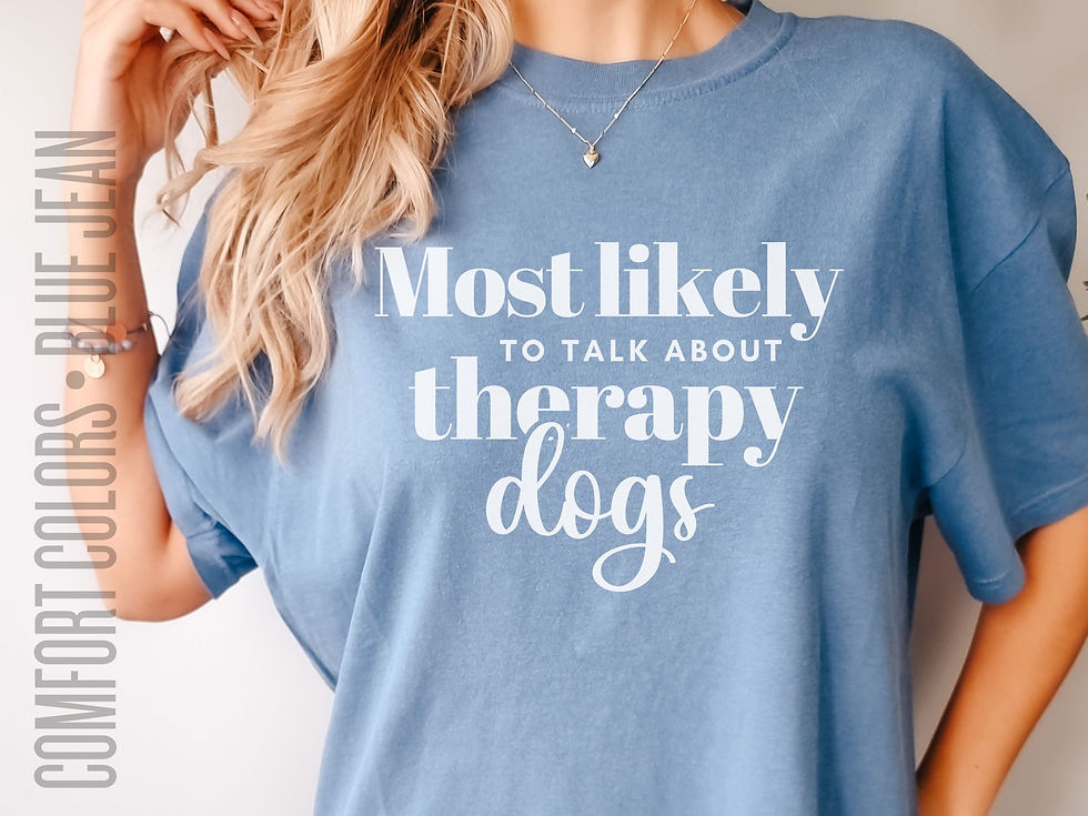 Thumbnail: Photo of woman's Blue Jean colored Comfort Colors t-shirt with the saying "Most Likely to Talk About Therapy Dogs"