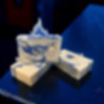 Blue and white marbled soap with 'owo' engraving and flame topper by Awa-Piko Soap