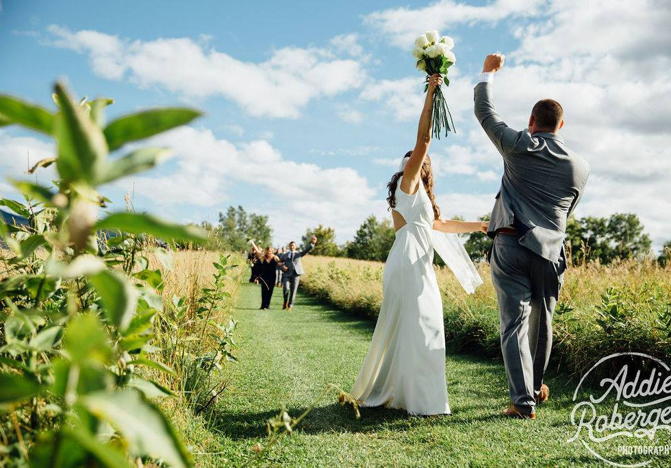 wedding couple celebrate near field aisle toad hill farm addie roberge photo.jpeg