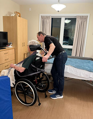 Michael Bastian helping a resident at a long-term care home in Ward 6, Mississauga