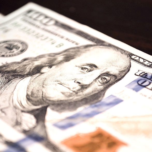 a stack of twenty dollar bills sitting on top of a table_edited_edited_edited.jpg