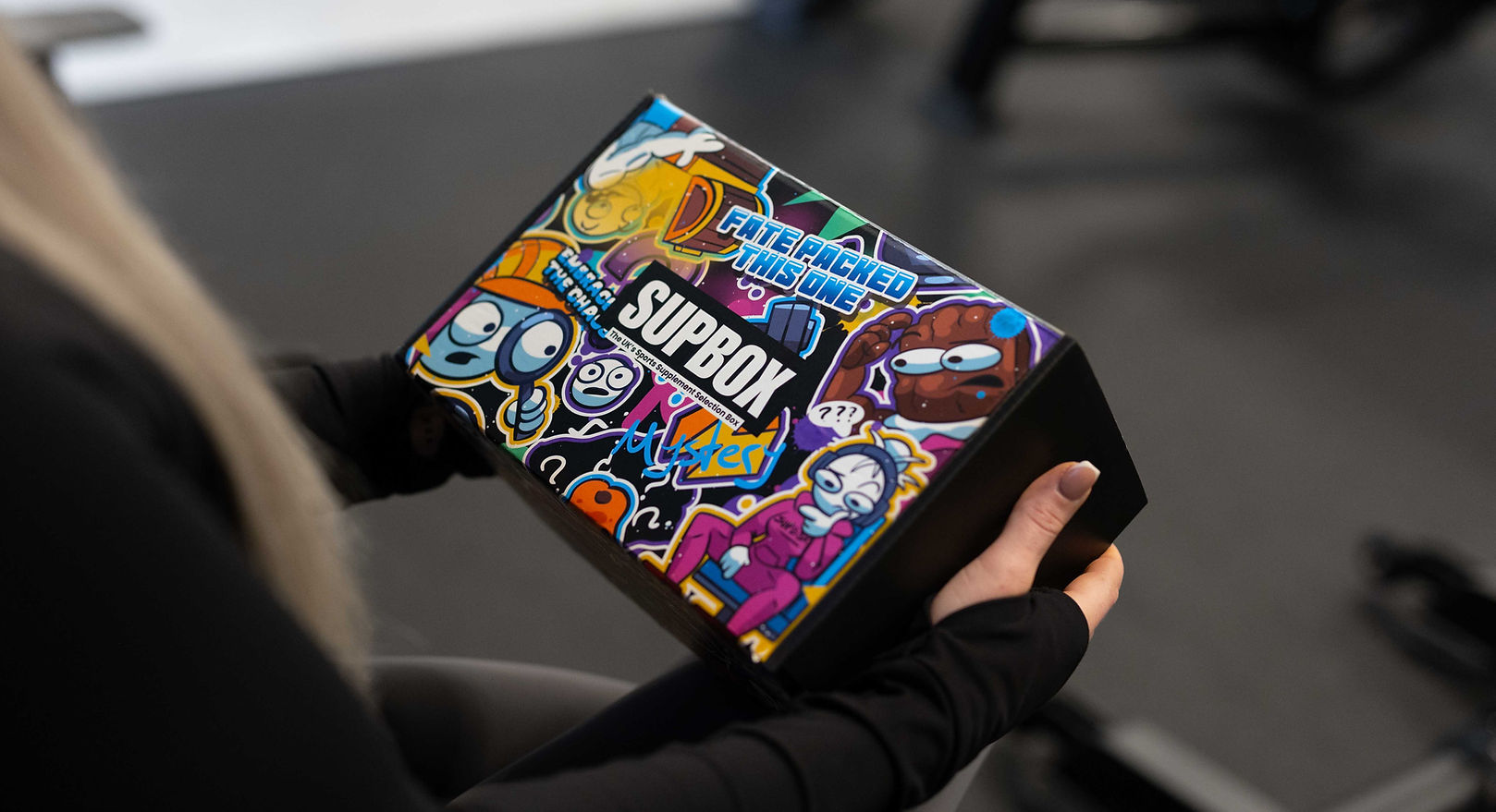 the exterior of a full protein mystery box with colourful branding.