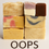 Thumbnail: A stacked assortment of Oops! Soap Bars in various colors and patterns, including swirls, layers, and speckled designs.