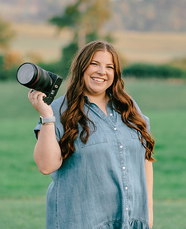 Rachel Dodson of Rachel Dodson Photography holding camera