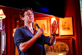 Stand-up comedian performing at 2nd Row Comedy at The Birdcage, a free comedy night in East London