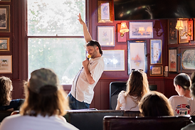Comedian performing to a laughing crowd at 2nd Row Comedy, Wednesday night at The Birdcage, Hackney, East London
