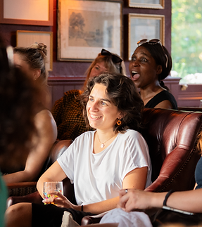 Comedy fans laughing in the front rows at 2nd Row Comedy, Wednesday night at The Birdcage pub, Hackney