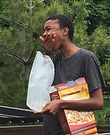 Close up of Elodie Edjang eating dry cereal in a dumpster