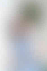 Meredith posing near greenery during her Fairhope senior portrait session.