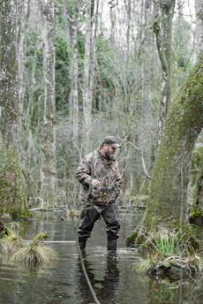 Duck hunters calling and watching the sky during early morning hunt