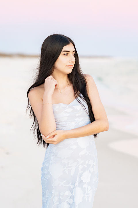 Senior girl standing along the shoreline during a beach Pensacola senior portrait session.