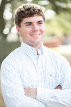 High school senior guy photographed during a senior portrait session with simple, neutral colors