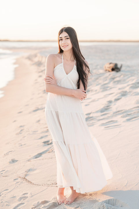 Senior girl standing along the shoreline during a beach Pensacola senior portrait session.