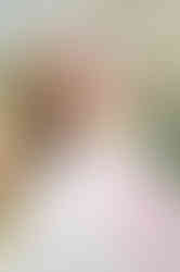 a Mobile Christian senior, standing among greenery and flowers during her Fairhope senior portrait session.