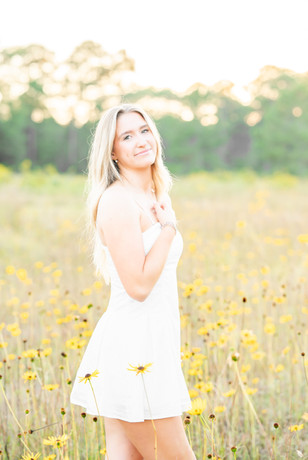 Senior girls portrait session in a yellow flower field along the Alabama Gulf Coast, photographed by April Grayson Photography.