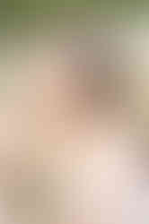 High school senior standing in a green field during a natural light Pensacola senior portrait session.