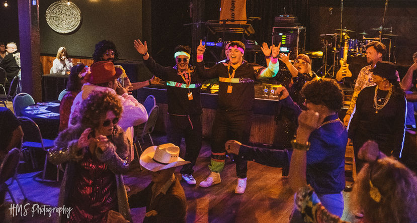 Guests celebrating together on the dance floor at a Beat the Funk event