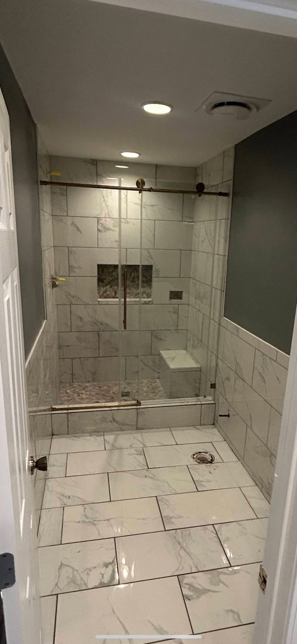 Custom tiled shower with glass enclosure