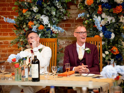 A bespoke broken arch using blue and orange florals for a wedding in Suffolk