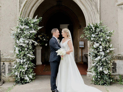 White rose and greenery floral arch for a church wedding in Dedham, Essex
