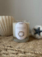 Christmas By The Coast, Charmed Candles, white background and decorated with seashells a neutral christmas bow 