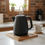 Thumbnail: Solid cherry wooden trivet holding a black tea kettle on a kitchen counter