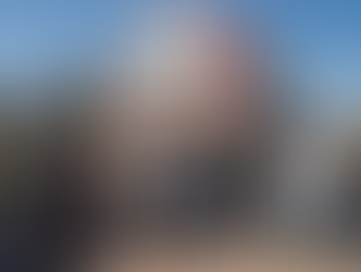 IISO Grade 10 students posing together in front of a traditional red‑roof house in Denenchofu during their Tamagawa field trip