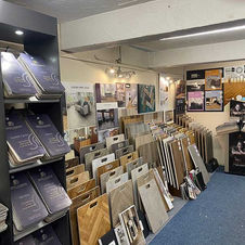 Showroom corner displaying multiple samples of carpets and luxury vinyl tiles