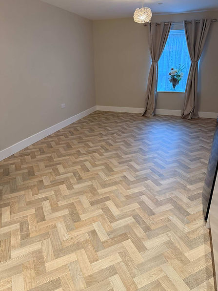 Modern light grey parquet flooring installed in a residential room