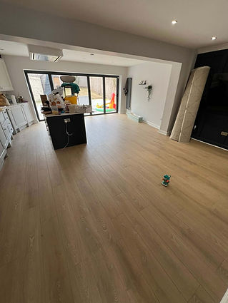 Spacious open plan kitchen and living area featuring newly fitted light oak wood laminate flooring