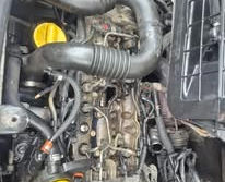 Up-close detailed view of car engine pipes, hoses, and fuel line connections.