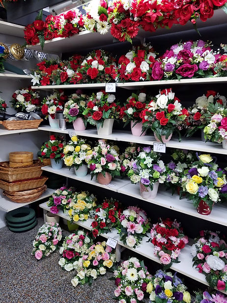Interior view of a Portadown florist shop showing colourful rose displays and wicker baskets