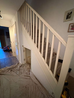 Modern wooden staircase with white balustrades